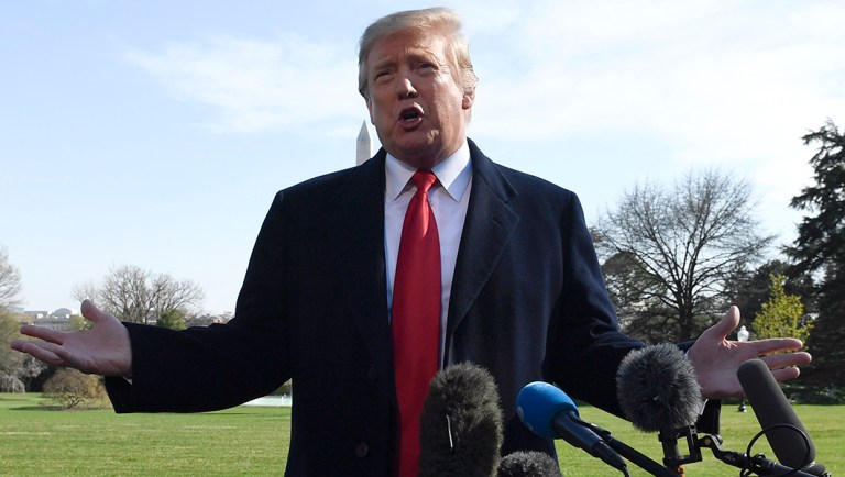 President Trump talks with reporters before boarding Marine One on the South Lawn of the White House.