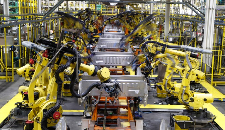 FILE- In this Sept. 27, 2018, file photo robots weld the bed of a 2018 Ford F-150 truck on the assembly line at the Ford Rouge assembly plant in Dearborn, Mich. On Monday, April 1, the Institute for Supply Management, a trade group of purchasing managers, issues its index of manufacturing activity for March.  