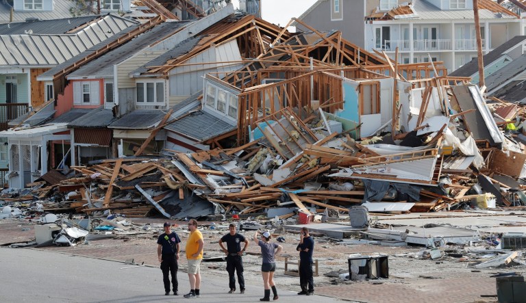 In this Thursday, Oct. 11, 2018, file photo, rescue personnel perform a search in the aftermath of Hurricane Michael in Mexico Beach, Fla. Weather forecasters have posthumously upgraded last fall's Hurricane Michael from a Category 4 storm to a Category 5.