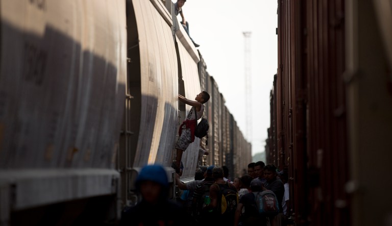 Central American migrants climb on a parked freight train during their journey toward the U.S.-Mexico border, in Ixtepec, Oaxaca State, Mexico, Tuesday, April 23, 2019. Mexican authorities started raiding the trains to pull migrants off in mid-2014 and the number of Central Americans aboard the train fell to a smattering.