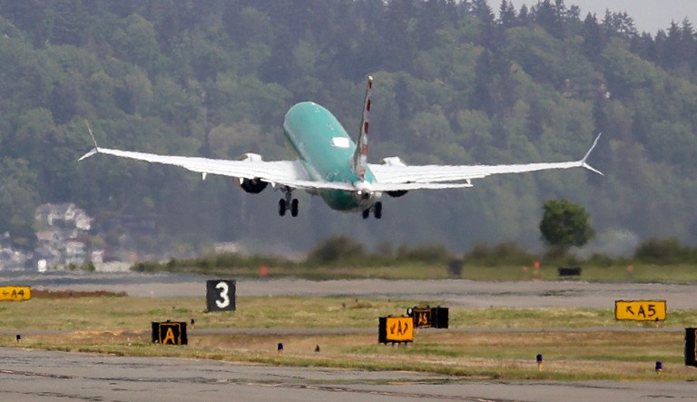 A Boeing 737 MAX 8, being built for American Airlines, is partially obscured by the engine wash as it takes-off on a test flight Wednesday, May 8, 2019, in Renton, Wash. The Boeing 737 Max 8s have been grounded following deadly crashes in Indonesia and Ethiopia. Analysts expect that idling the Max 8s, a fuel-efficient update of Boeing's popular 737, will crimp growth plans in the near future. 