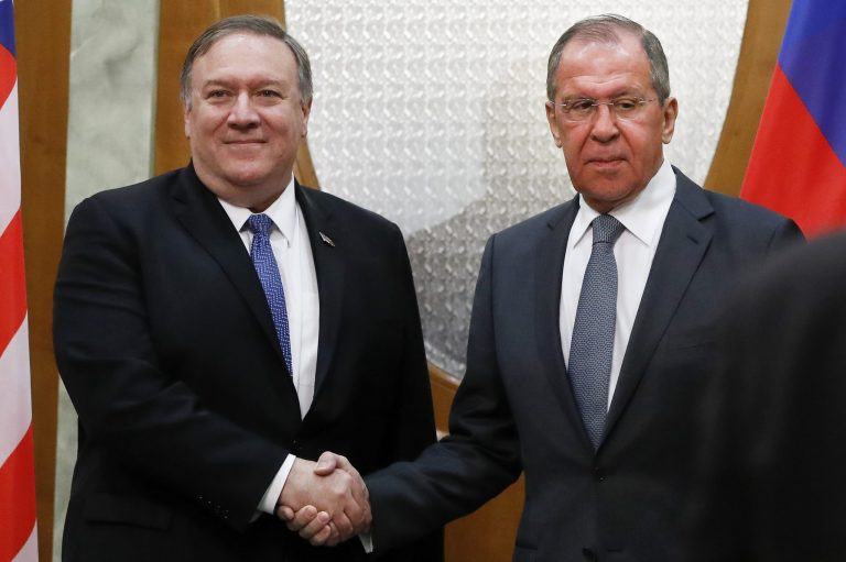 U.S. Secretary of State Mike Pompeo, left, and Russian Foreign Minister Sergey Lavrov shake hands.