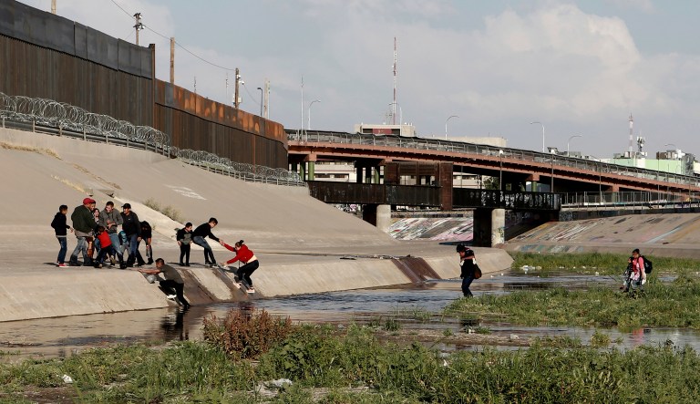 Migrant families cross the Rio Grande to get illegally across the border into the United States, to turn themselves in to authorities and ask for asylum, next to the Paso del Norte international bridge, near El Paso, Texas.
