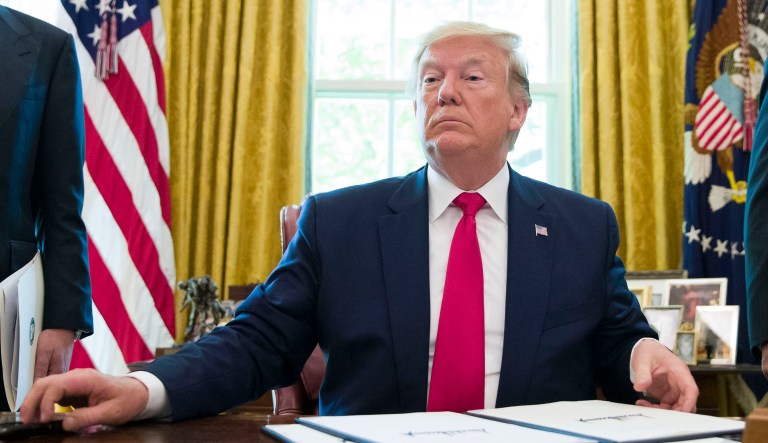 President Trump sits in the Oval Office of the White House.