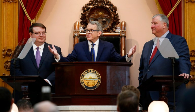 Ohio Gov. Mike DeWine, center, speaks between Ohio Senate President Larry Obhof, left, and Ohio House Speaker Larry Householder.