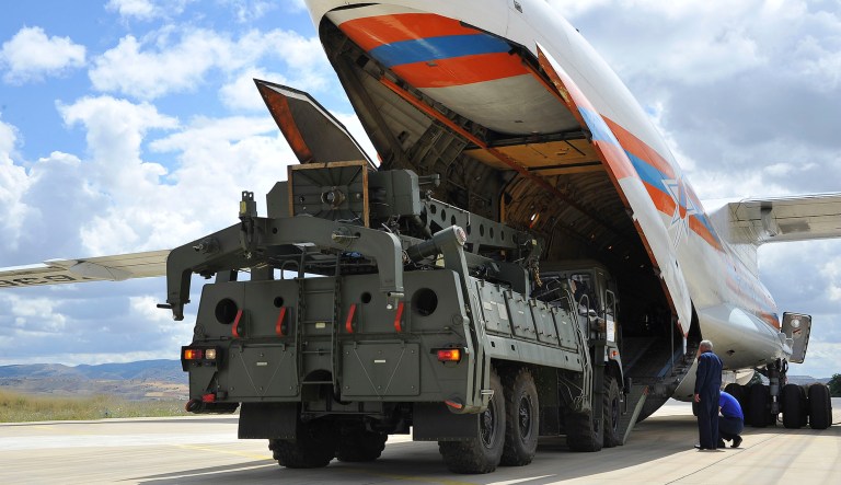 Military vehicles and equipment, parts of the S-400 air defense systems, are unloaded from a Russian transport aircraft, at Murted military airport in Ankara, Turkey, on Friday. The first shipment of a Russian missile defense system has arrived in Turkey, the Turkish Defense Ministry said Friday, moving the country closer to possible U.S. sanctions and a new standoff with Washington. The U.S. has strongly urged NATO member Turkey to pull back from the deal, warning the country that it will face economic sanctions. 