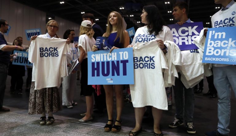 Supporters of both Conservative party leadership candidates Boris Johnson and Jeremy Hunt stand outside the hall before a Conservative leadership hustings at ExCel Centre in London, Wednesday, July 17, 2019. 