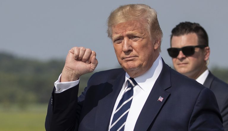 President Donald Trump gestures upon arrival at Morristown Municipal Airport, in Morristown, N.J., Friday, July 19, 2019.
