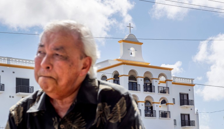 Leo Tudela recalls his allegations of sexual abuse at age 13 by a monk at the Saint Fidelis Friary, seen in the background, in Hagatna, Guam. Tudela was eventually moved to live in the rectory of another church where Rev. Louis Brouillard took interest in him. That began an eight-month period during which Tudela alleges he was regularly raped and molested. "We're all human beings, so there is always forgiveness, but this person, I don't think God will forgive him," he said. Brother Mariano Laniyo and Brouillard are now dead. Brouillard acknowledged abuse allegations before he died.