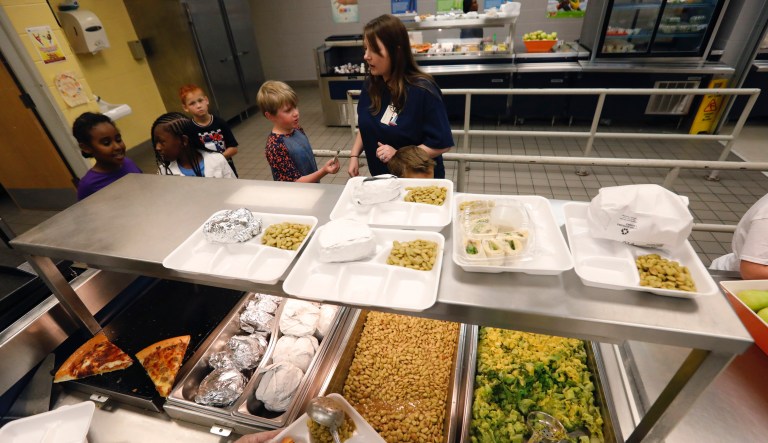 Man cuts a check to cancel the lunch debt for every student in a Florida public school