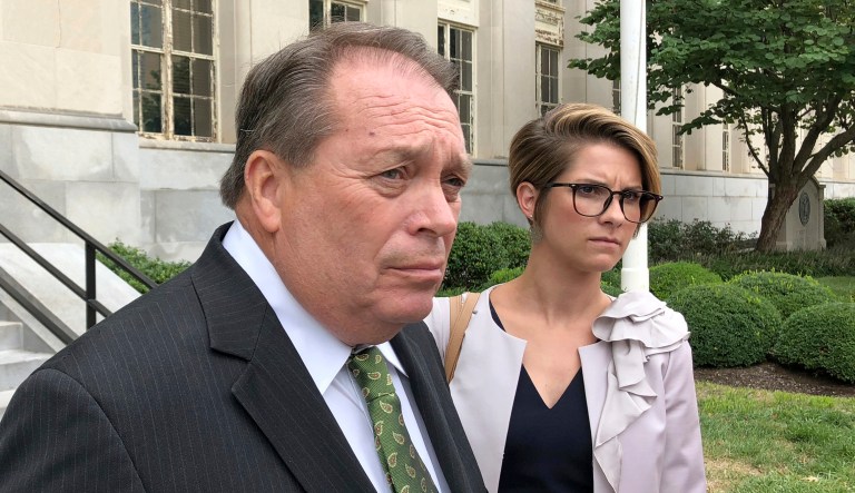 Jerry Lundergan (left), the father of Kentucky Secretary of State Alison Lundergan Grimes, leaves the federal courthouse with his attorney Whitney True Lawson, in Lexington, Kentucky.