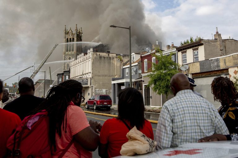 Members of Greater Bible Way Temple watch outside as the church burns.