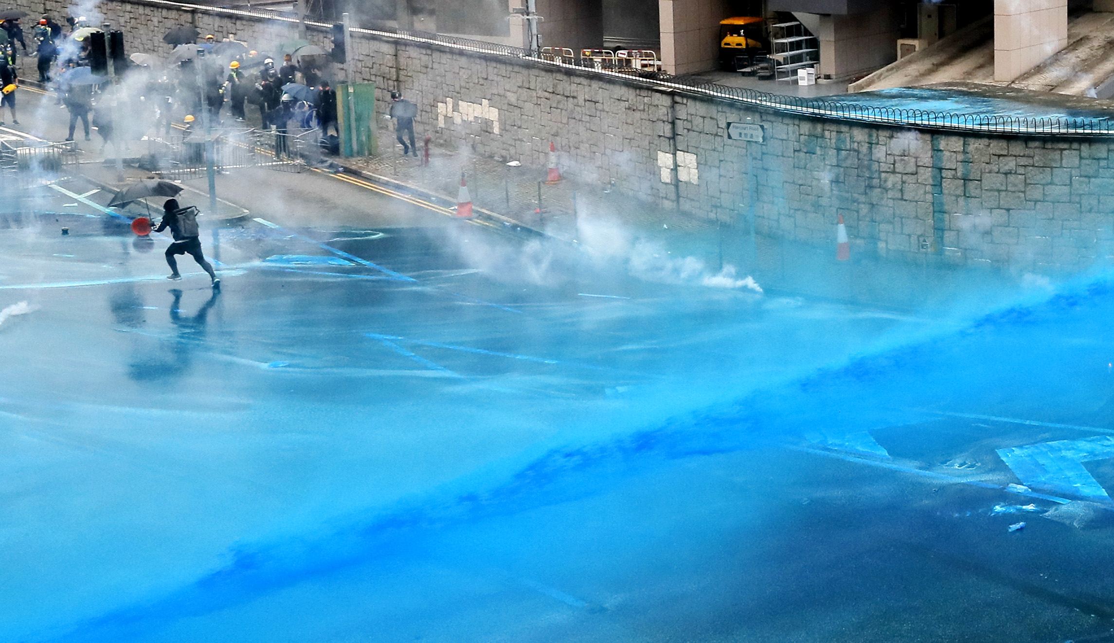 Police in Hong Kong blast protesters with blue dye as violence erupts in the streets