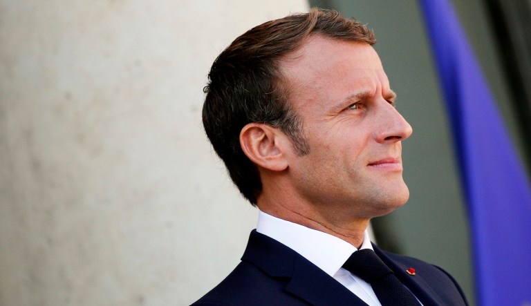French President Emmanuel Macron waits before an event.