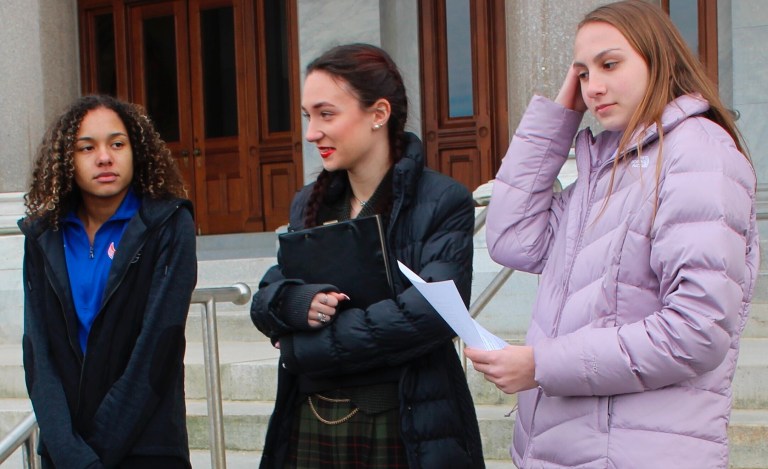 High school track athletes Alanna Smith, left, Selina Soule, center, and Chelsea Mitchell prepare to speak at a news conference outside the Connecticut State Capitol in Hartford, Connecticut, Wednesday, Feb. 12, 2020. The three girls have filed a federal lawsuit to block a state policy that allows transgender athletes to compete in girls' sports. 