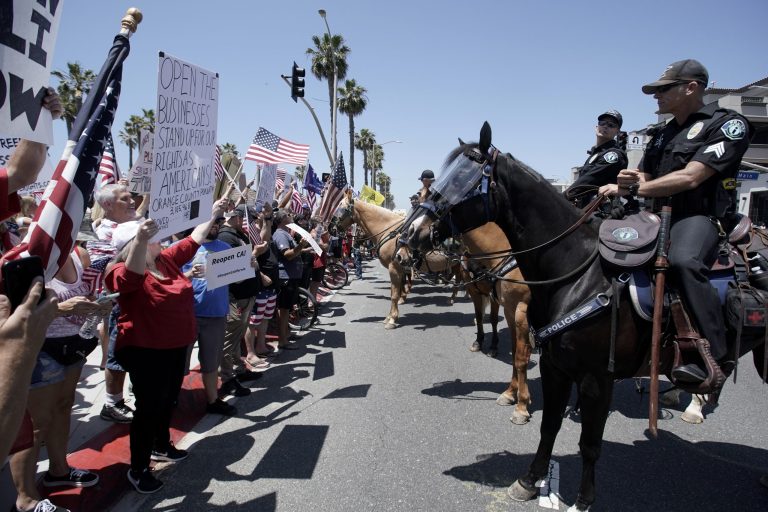 More than 500 people storm California beach town to protest stay-at-home orders