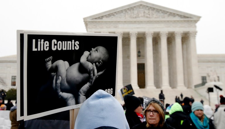 A marcher holds a sign during the 2016 March for Life in front of the U.S. Supreme Court in Washington, D.C.
