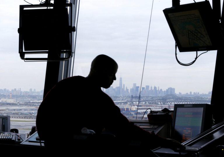 In this photo, an air traffic controller works in the tower at Newark Liberty International Airport in Newark, N.J. 