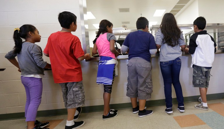Detained immigrant children line up in the cafeteria at the Karnes County Residential Center, a temporary home for immigrant women and children detained at the border in Karnes City, Texas.