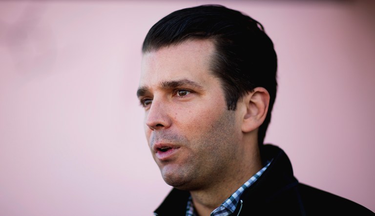 Donald Trump Jr. talks to reporters while campaigning for his father.