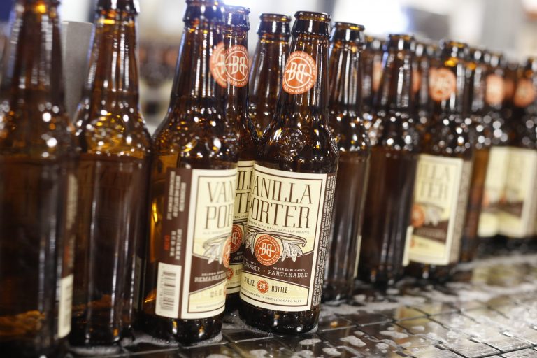 Bottles of beer head to be filled on line in the factory of Breckenridge Brewery in Littleton, Colo.