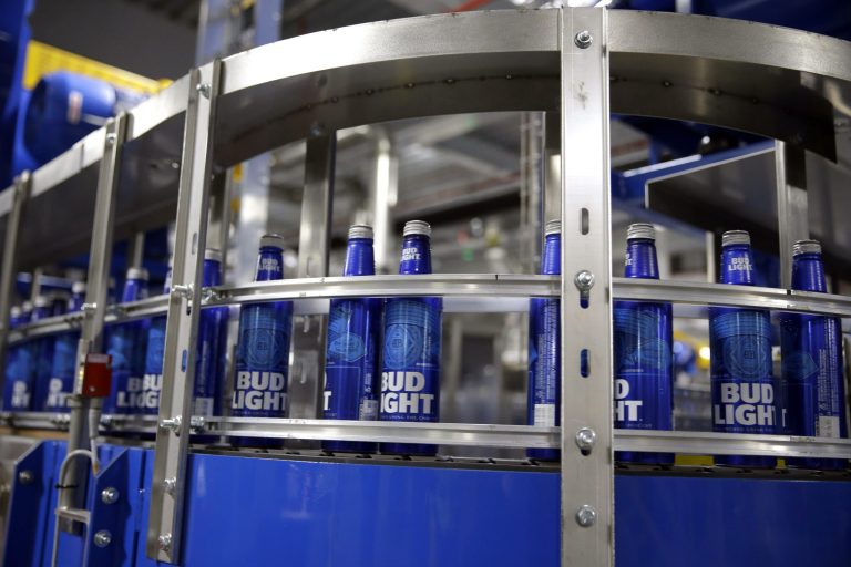 Aluminum Bud Light beer bottles move along a conveyor inside a facility that makes 16-ounce aluminum Budweiser and Bud Light bottles for Anheuser-Busch.