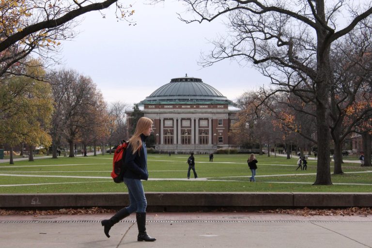 In this 2015 file photo, University of Illinois students walk across the Main Quad on campus in Urbana, Ill.