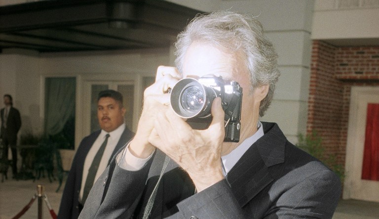 Clint Eastwood photographs the media at the premiere of a film at Warner Bros. Studios in Burbank, Calif., on May 30, 1995.