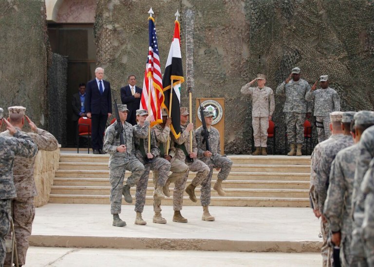 The US flag, the Iraqi flag, and the US Forces Iraq colors are seen before they are carried in during ceremonies marking the end of US military mission in Baghdad, Iraq, Thursday, Dec. 15, 2011. After nearly nine years, 4,500 American dead, 32,000 wounded and more than $800 billion, U.S. officials formally shut down the war in Iraq, a conflict that U.S. Defense Secretary Leon Panetta said was worth the price in blood and money.
