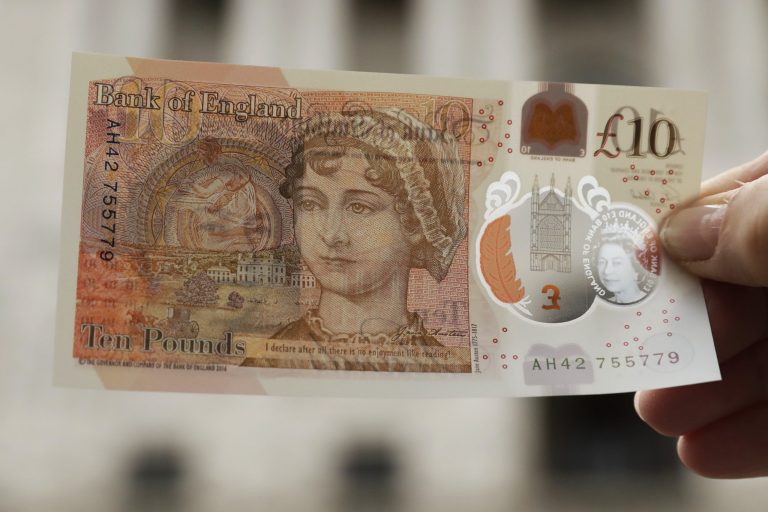 One of the new British 10 pound notes is posed for photographs outside the Bank of England in the City of London, Thursday, Sept. 14, 2017. (AP Photo/Matt Dunham)