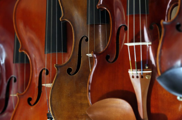 Different violins hanging on the wall in violin maker Jan Nemcek's workshop in the northern Serbian village of Kovacica, Wednesday, Oct. 4, 2017. 