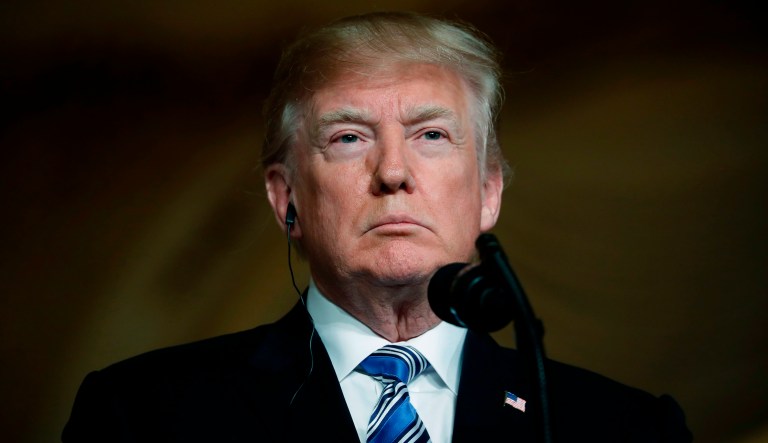 President Trump listens during a news conference in Palm Beach, Fla. 