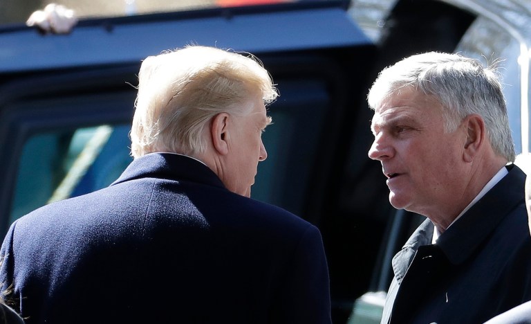 Then-President Donald Trump speaks with pastor Franklin Graham.