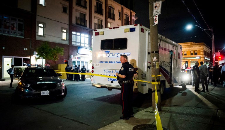 Police secure a perimeter around the scene of a shooting in Toronto on Monday, July 23, 2018. 