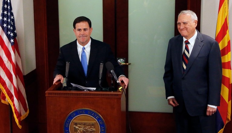 Gov. Doug Ducey, R-Ariz., left, pauses as he announces the appointment of the former Sen. Jon Kyl, R-Ariz. to fill Sen. John McCain's seat in the U.S. Senate at a news conference at the Arizona Capitol. 