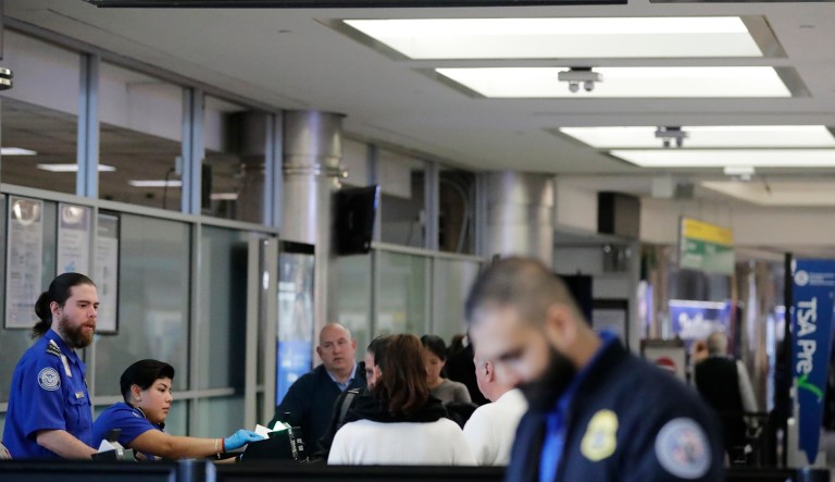 Passengers stand in line as they wait to pass through a Transportation Security Administration checkpoint at LaGuardia airport Monday, Jan. 7, 2019, in New York.