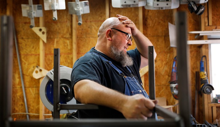 Jack Lyons, a contractor working on massive rocket test stands for NASA, stands in his workshop while spending the furlough on his small side business making props for marching bands, in Madison, Ala., Tuesday, Jan. 8, 2019. "They're trying to use people as bargaining chips, and it just isn't right," Lyons said. Unlike civil service workers who expect to eventually get back pay, Lyons doesn't know if he'll ever see a dollar from the shutdown period. 