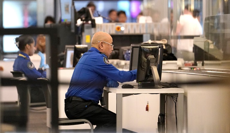 Transportation Security Administration officials work at the entrance to a concourse at San Francisco International Airport, Tuesday, Jan. 8, 2019, in San Francisco. The federal government shutdown is nearing a fourth week.
