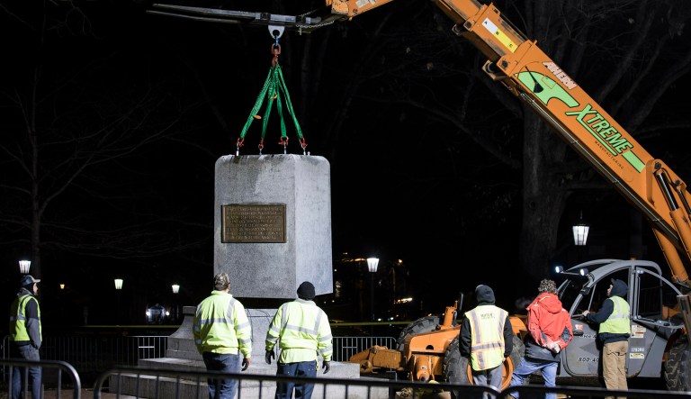 The first and largest piece of the remnants of a Confederate statue known as "Silent Sam" is lifted before being transported to the bed of a truck early Tuesday,  Jan. 15, 2019 on the campus of the University of North Carolina in Chapel Hill, N.C.  The last remnants of the statue were removed at the request of UNC-Chapel Hill Chancellor Carol Folt, who also announced her resignation in a move that increases pressure on the system's board of governors to give up on plans to restore the monument. 