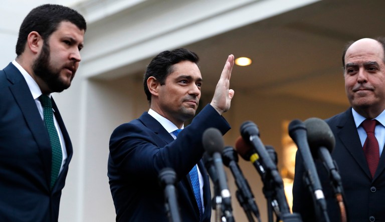 Venezuela's Carlos Vecchio, center, with David Smolansky, left, and Julio Borges, gestures after speaking to the media after meeting with Vice President Mike Pence, Tuesday, Jan. 29, 2019, at the White House in Washington.