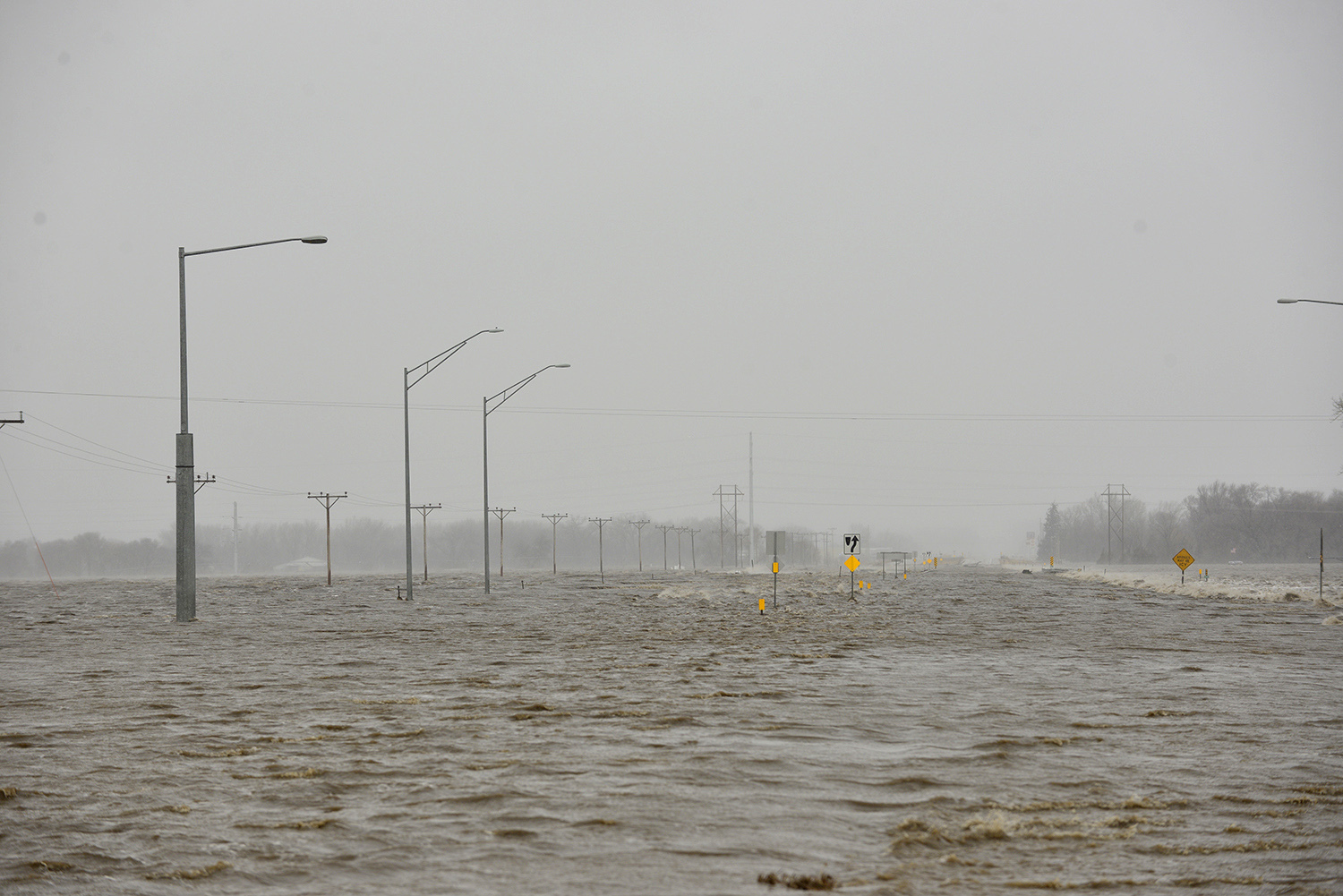 Highway 81 north of Norfolk, Neb., is covered in flood waters. Thousands of people have been urged to evacuate along eastern Nebraska rivers as a massive late-winter storm has pushed streams and rivers out of their banks throughout the Midwest.