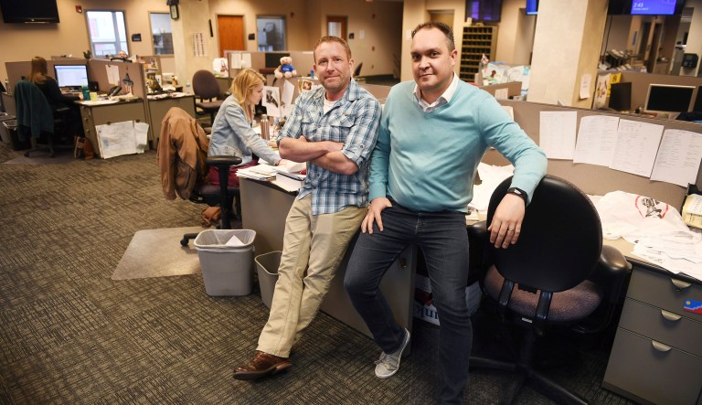 In this April 9, 2019, photo, Argus Leader investigative reporter Jonathan Ellis and news director Cory Myers in the newsroom in Sioux Falls, S.D.