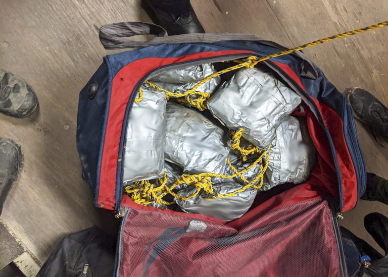 This photo provided by U.S. Customs and Border Protection shows over 165 pounds of suspected methamphetamine and fentanyl seized after smugglers tried to float it across the border from Nogales, Mexico, by roping together dozens of packages and sending them through an underground drainage tunnel into Arizona.
