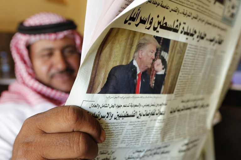 A man holds the daily Asharq Al-Awsat newspaper fronted by a picture of President Donald Trump, at a coffee shop in Jiddah, Saudi Arabia, Wednesday, Jan. 29, 2020. The paper reads "Trump plan... new borders between Palestine and Israel."