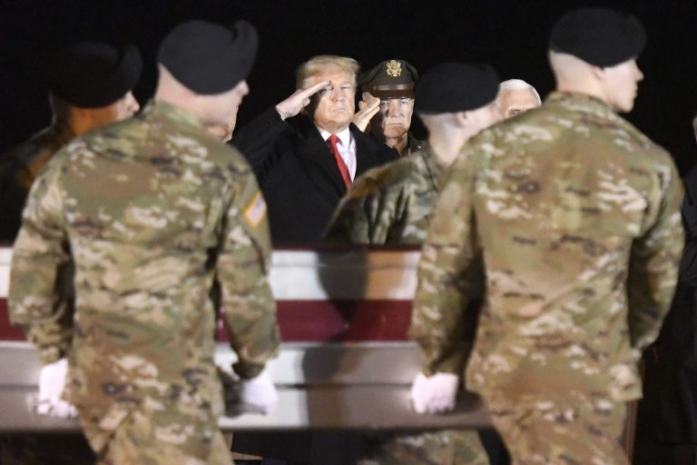 President Donald Trump, left, and Army Chief of Staff Gen. James C. McConville salute as an Army carry team moves a transfer case containing the remains of Sgt. 1st Class Antonio Rey Rodriguez, Monday, Feb. 10, 2020, at Dover Air Force Base, Del. According to the Department of Defense, Rodriguez, 28, of Las Cruces, N.M., died in Nangarhar province, Afghanistan, of wounds sustained during combat operations. Vice President Mike Pence is partially visible at right.
