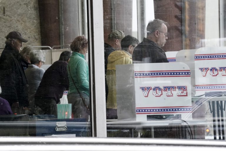 In this Wednesday, March 18, 2020, photo, early voters cast their ballots at the Zeidler Municipal Building in Milwaukee.