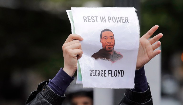A picture of George Floyd is seen amid protests across the United States over his death after an officer knelt on Floyd's neck for several minutes.