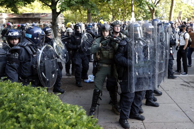 Police clear the area around Lafayette Park and the White House as demonstrators gather to protest the death of George Floyd, Monday, June 1, 2020, in Washington. Floyd died after being restrained by Minneapolis police officers. 