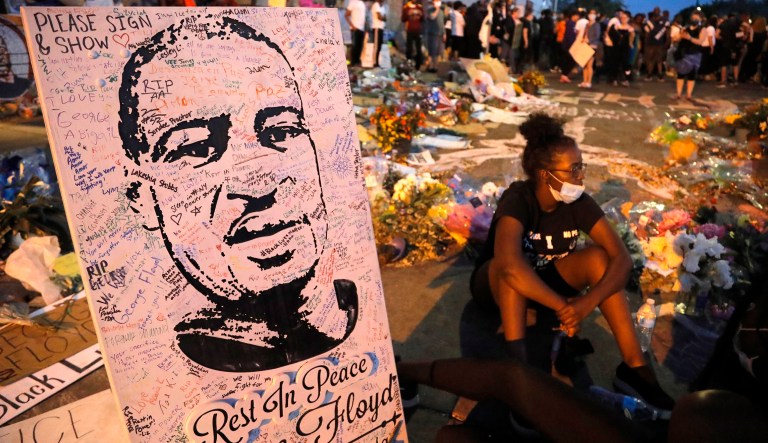 A picture of George Floyd is seen amid protests across the United States over his death after an officer knelt on Floyd's neck for several minutes.