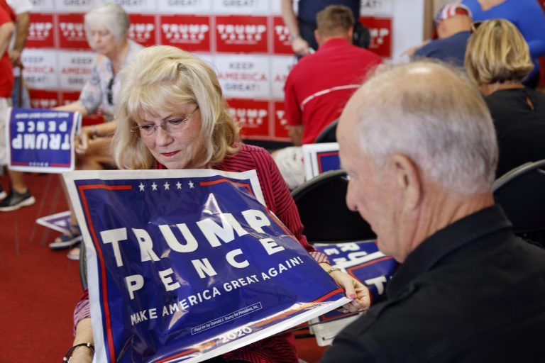 Arlene and Earl Speas assemble Trump Pence yard signs ahead of the opening of the Nebraska Trump Victory Office in Omaha, Neb., Thursday, Aug. 20, 2020. The party has invested heavily in its ground game to help the whole GOP ticket.